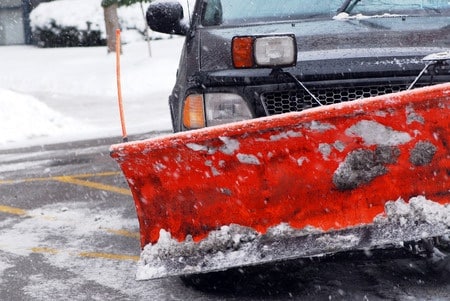 Work truck with snow plow, plowing residential driveways